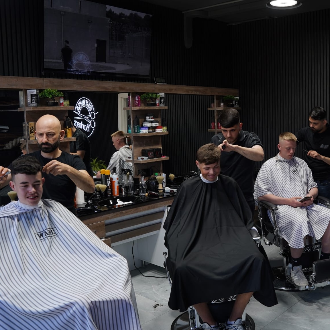 Inside Olympia Barbers on the Ormeau Road, Belfast, with barber chairs in use